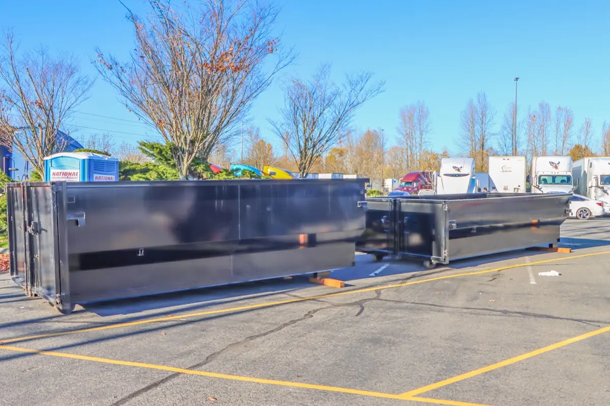 Professional dumpster rental service with roll-off container on residential driveway in Glenwood